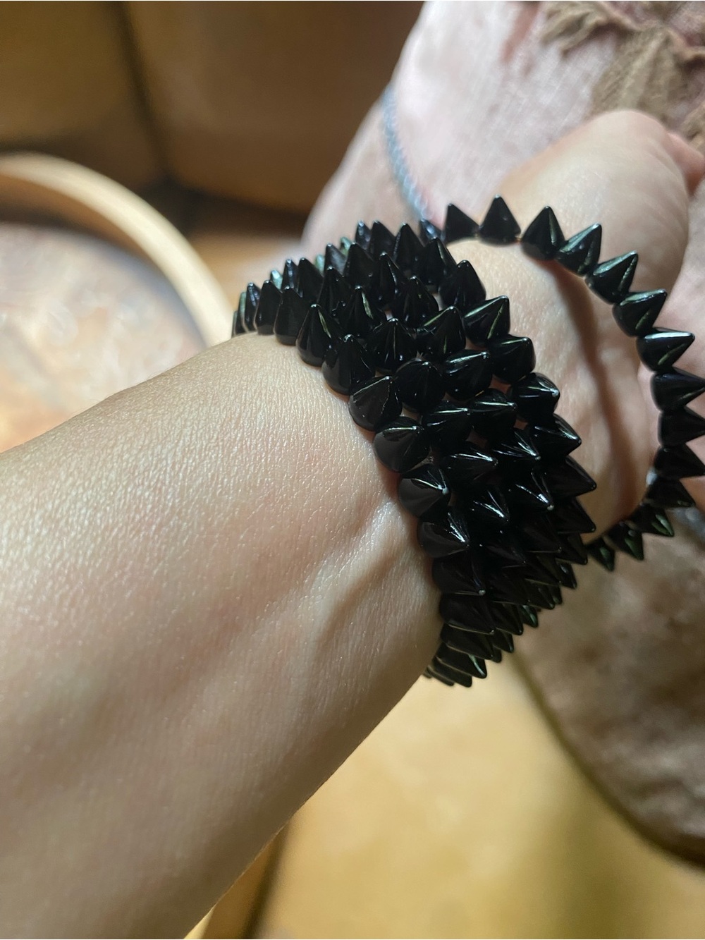 Black spike stacking bracelets with gold accents